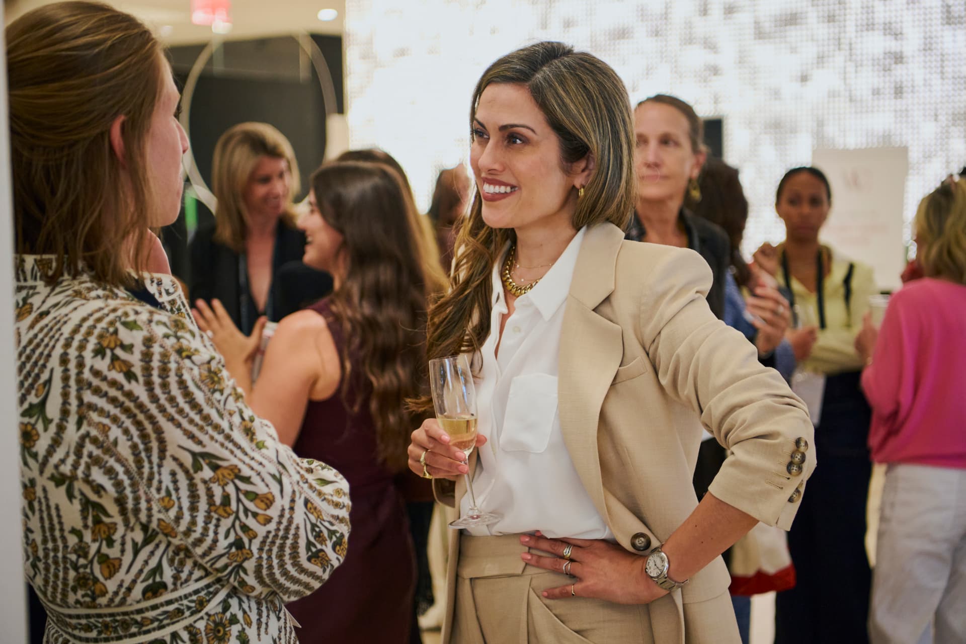 A guest smiling in open conversation at a networking break